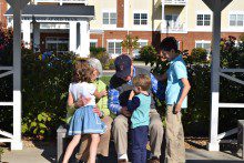 Commercial-shoot-038R-220x147 a group of children and adults are sitting on a bench